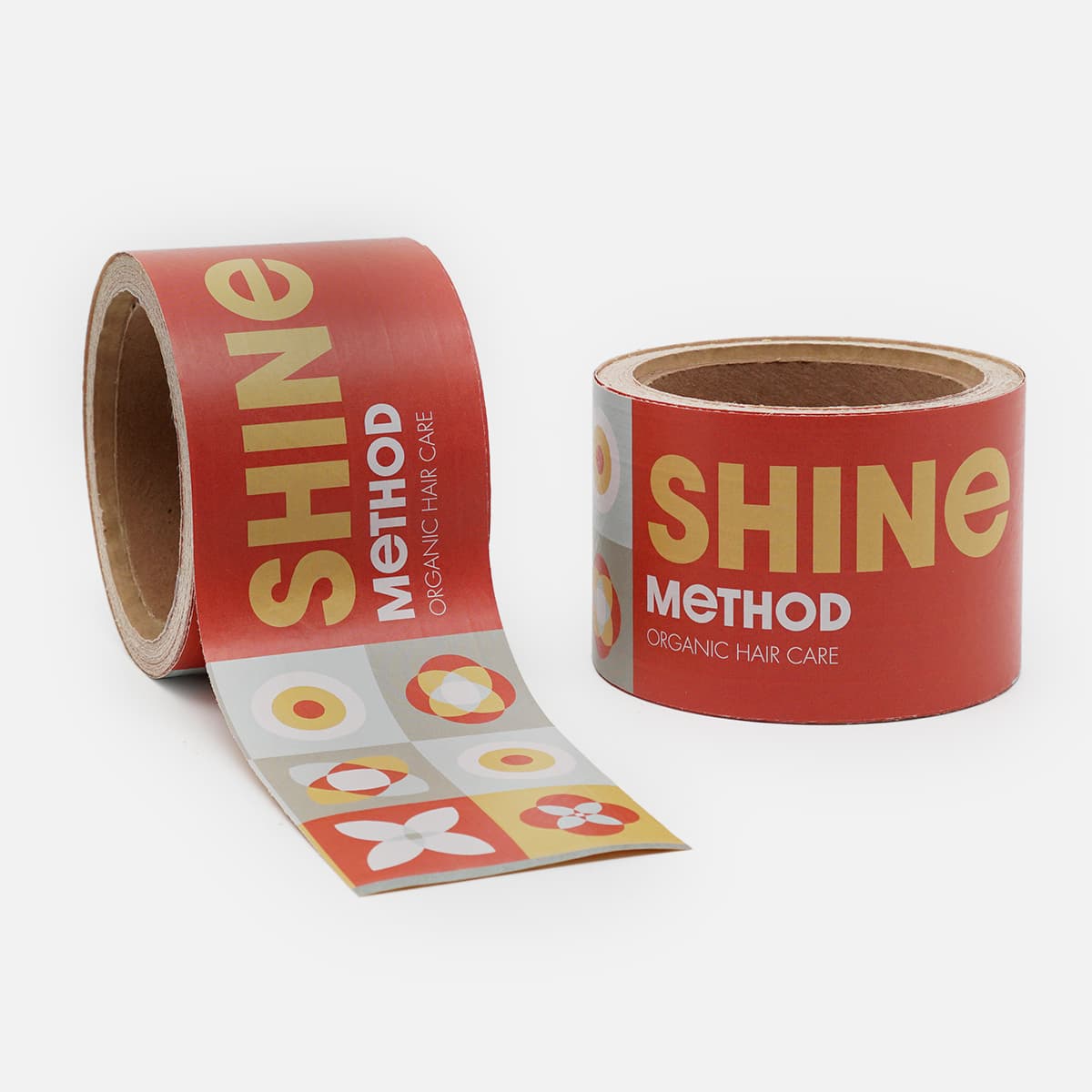 Red custom printed packaging tape for Shine Method Organic Hair Care featuring branded graphics and logo.