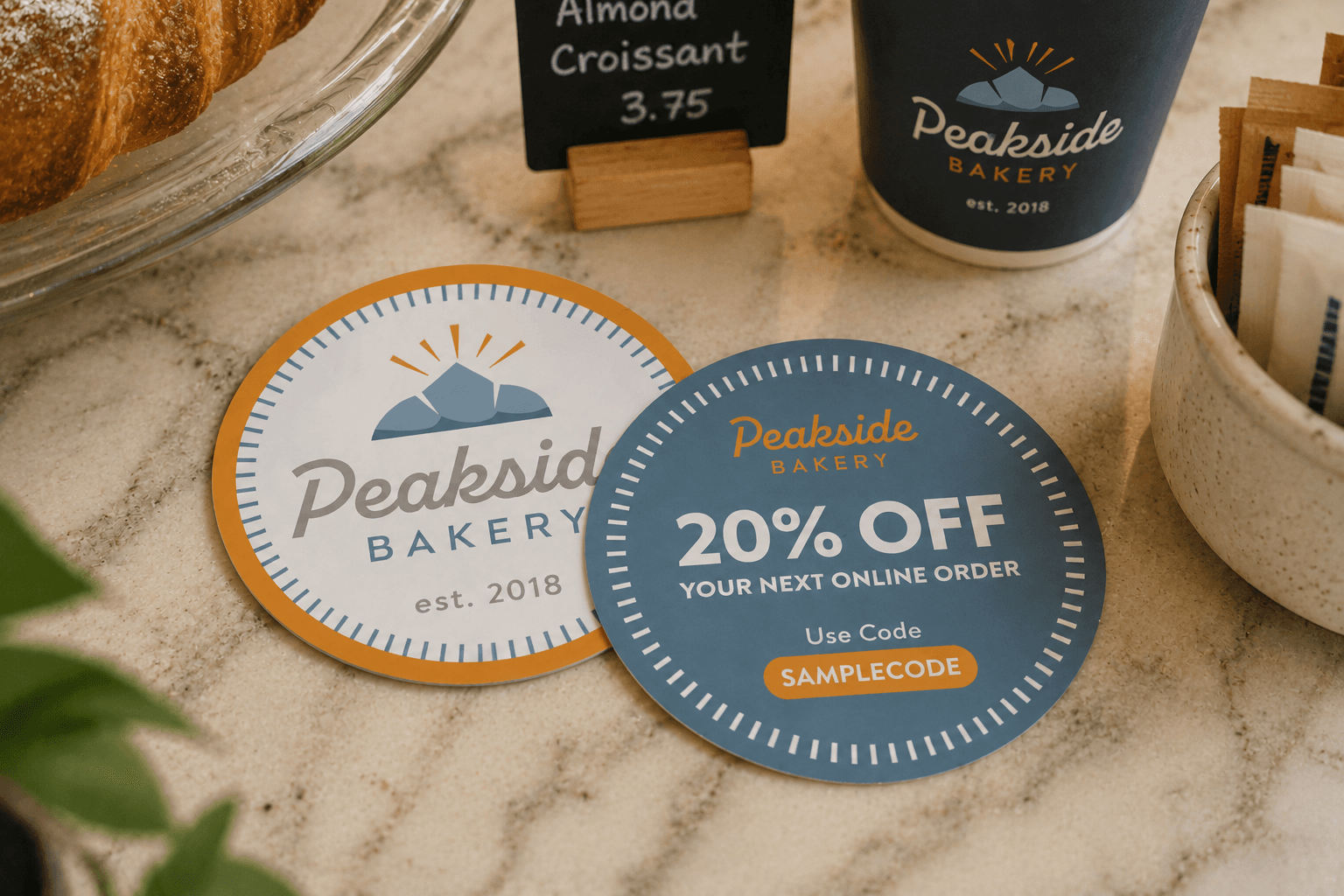 Backprinted bakery stickers featuring a logo and promotional discount on a bakery counter.