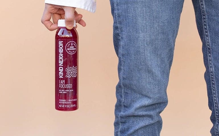 Custom clear label applied to a bottled wellness drink, showcasing transparent product labels for beverage packaging and consumer brands.