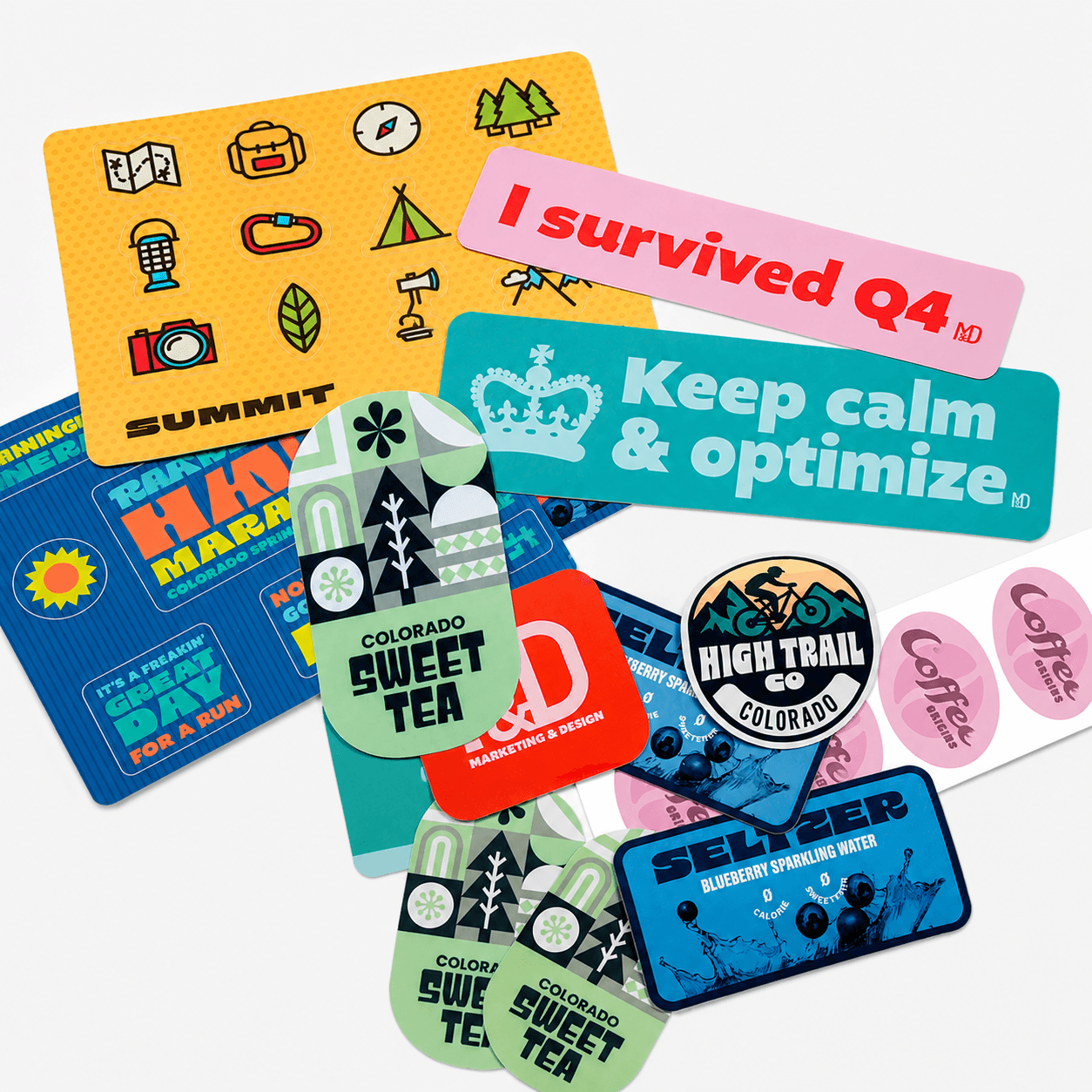 Assortment of custom stickers including die cut stickers, sticker sheets, bumper stickers, and branded promotional stickers.