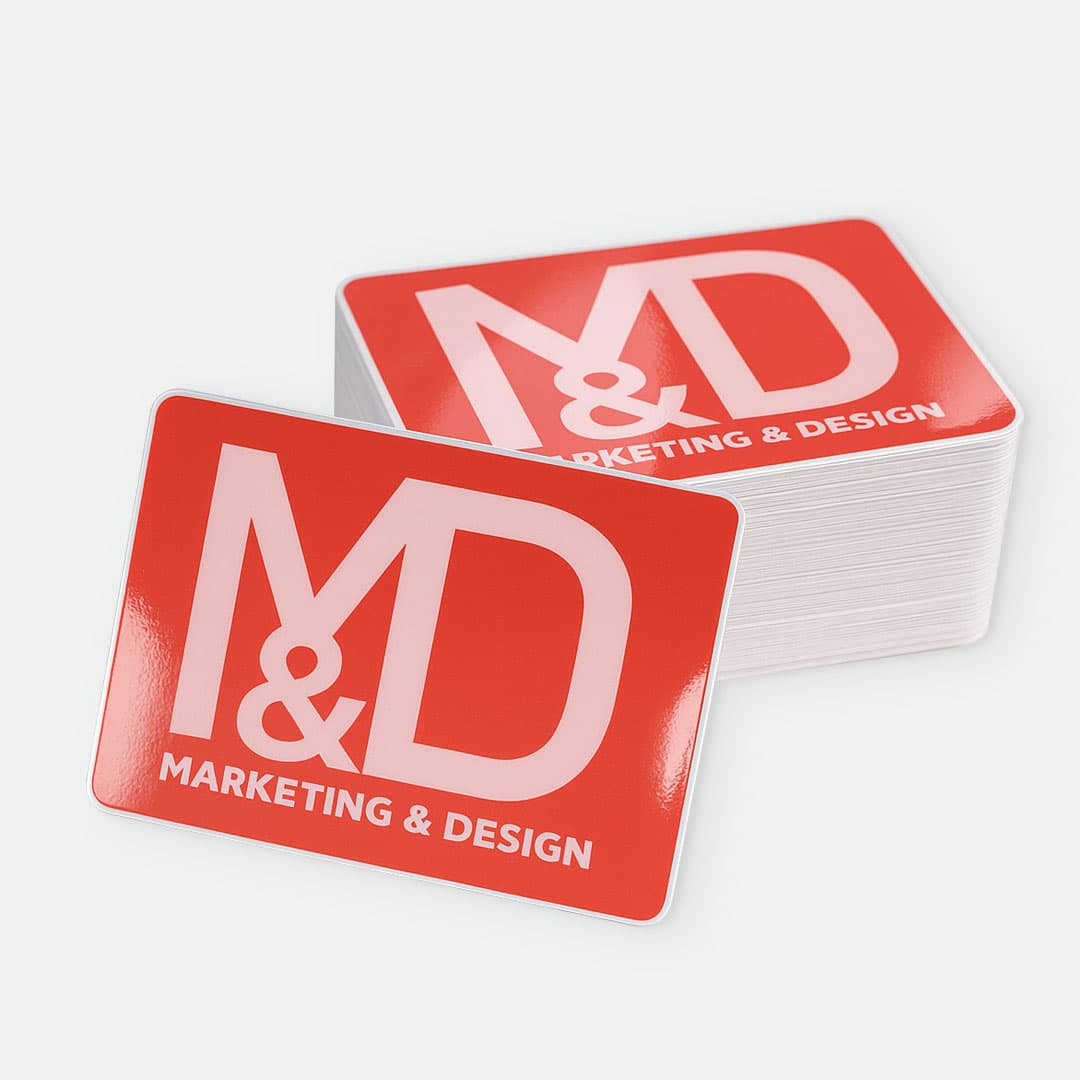 Stack of Marketing & Design custom rectangle stickers with glossy laminate, rounded corners, and vibrant full color printing.