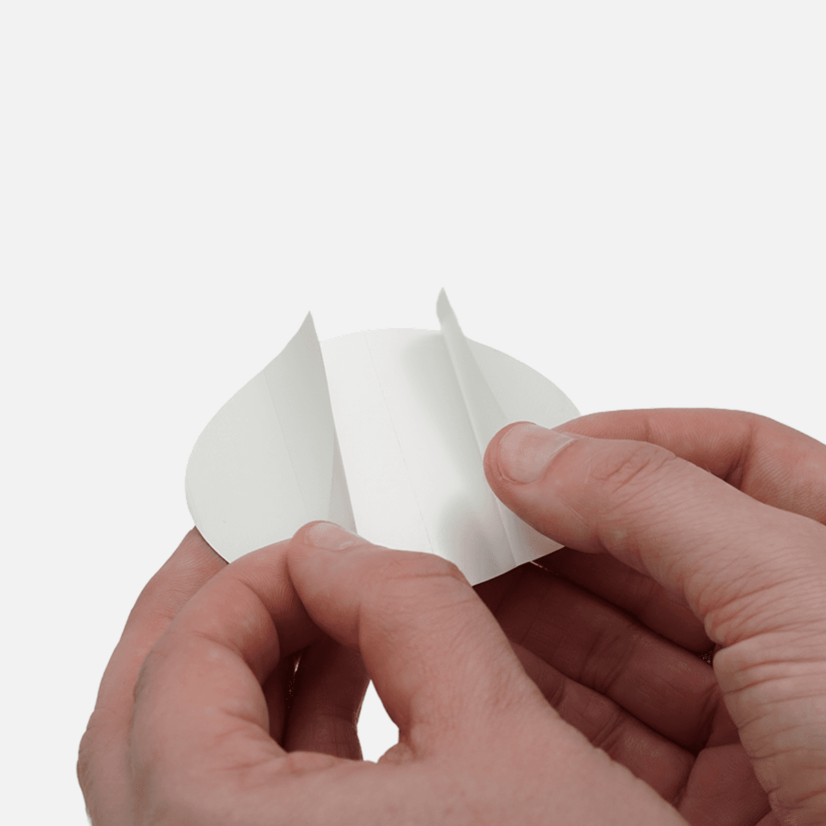 Oval custom sticker with split backing partially opened to show easy peel application.