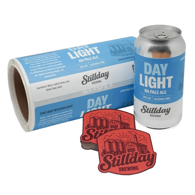 Custom beverage labels applied to aluminum cans with matching promotional stickers, demonstrating high-quality beer, brewery, and non-alcoholic beverage packaging solutions.