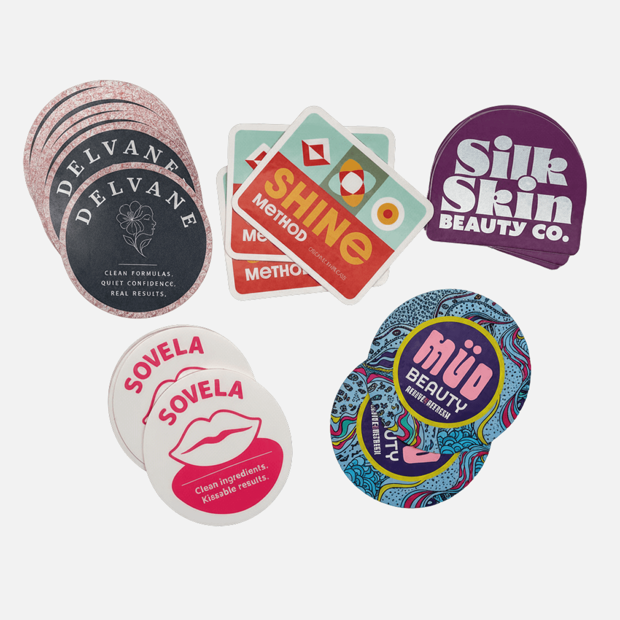 Collection of custom beauty brand stickers including die cut and round stickers for skincare, cosmetics, and wellness product packaging.