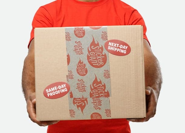 Person holding a shipping box sealed with custom branded packaging tape and promotional stickers highlighting same-day proofing and next-day shipping.