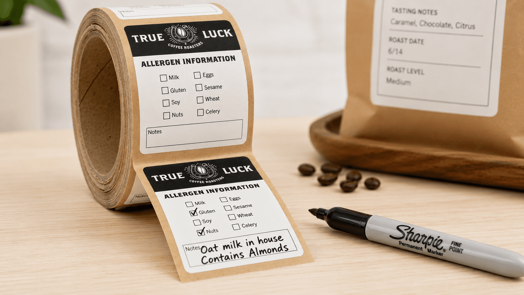 Kraft paper roll labels with handwritten allergen notes made using a permanent marker, demonstrating writable paper labels for food packaging.