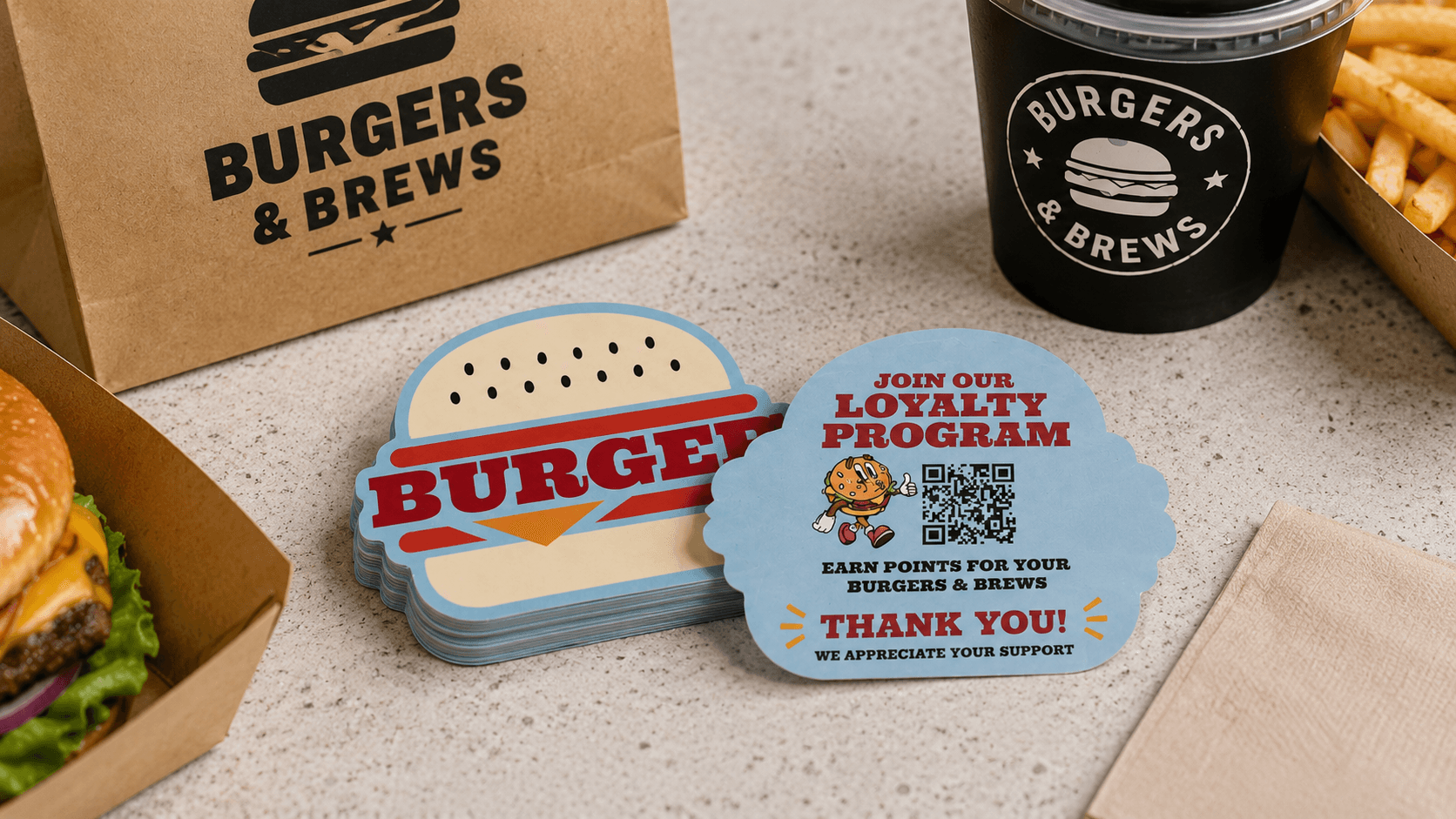 Burger restaurant stickers with a loyalty program QR code and thank you message printed on the back.