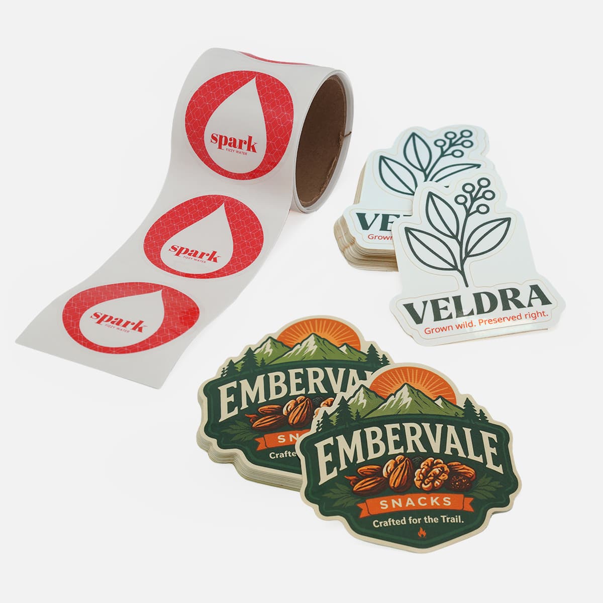 Custom die cut promotional stickers and branded giveaway stickers displayed for consumer product marketing and events.
