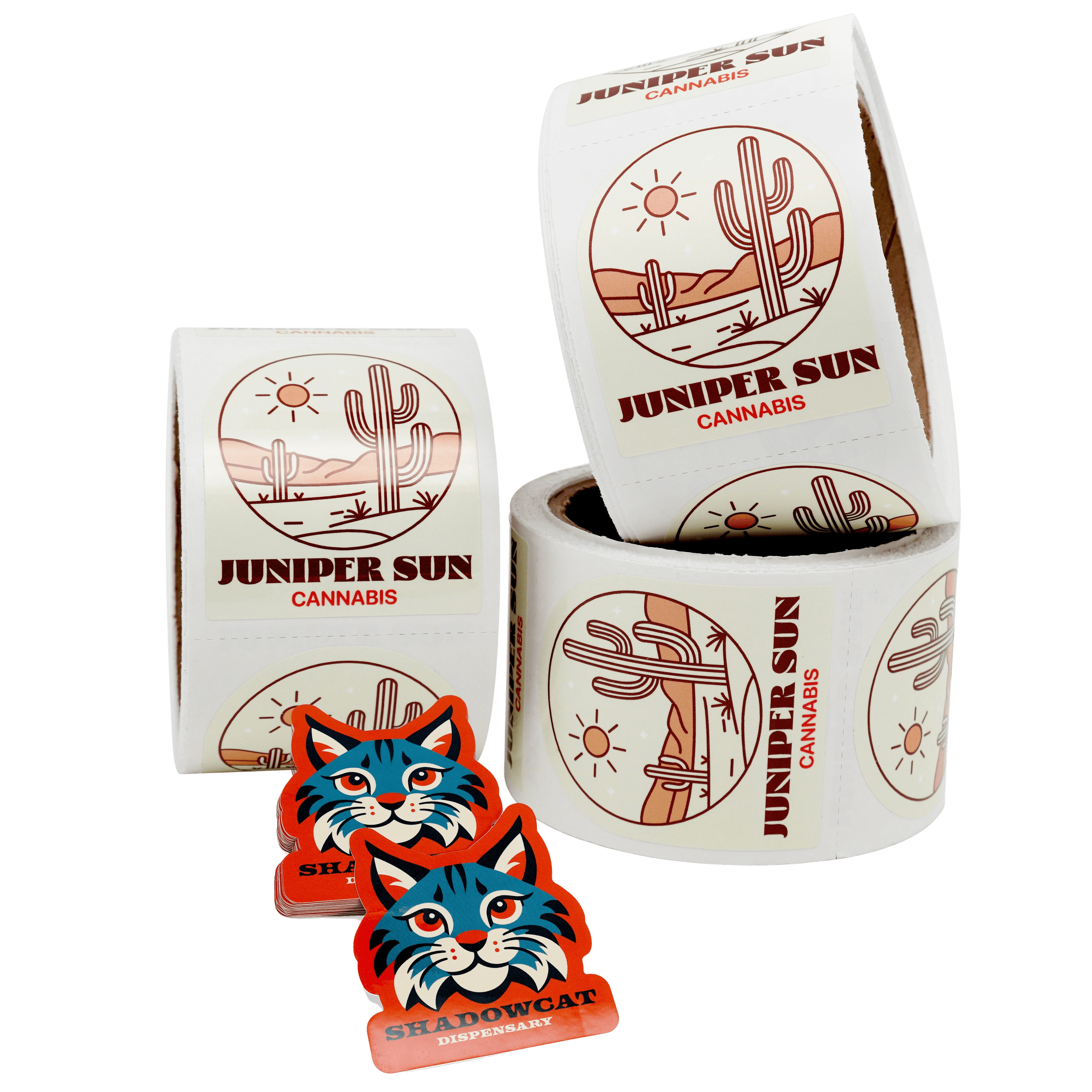 Custom cannabis product labels on rolls alongside branded die cut stickers, showcasing premium packaging labels and promotional stickers for dispensary and cannabis brand packaging.
