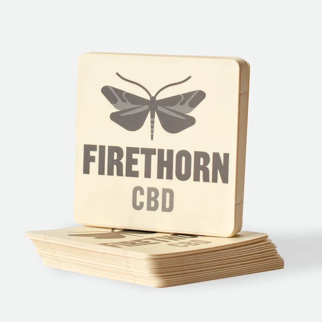 Stack of Firethorn CBD custom square stickers with rounded corners and premium full color printing.