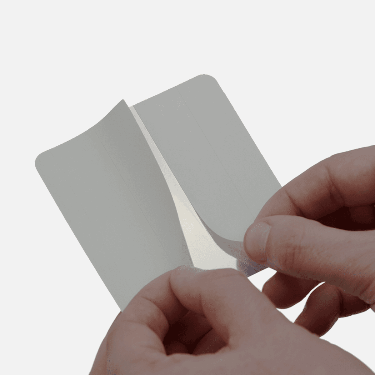 Square custom sticker with split backing partially peeled to demonstrate easy application.