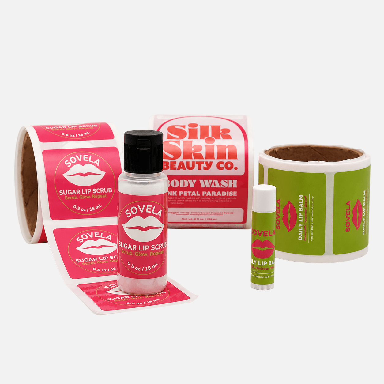 Custom laminated labels for beauty and skincare products applied to lip balm tubes, lip scrub bottles, body wash packaging, and cosmetic label rolls.