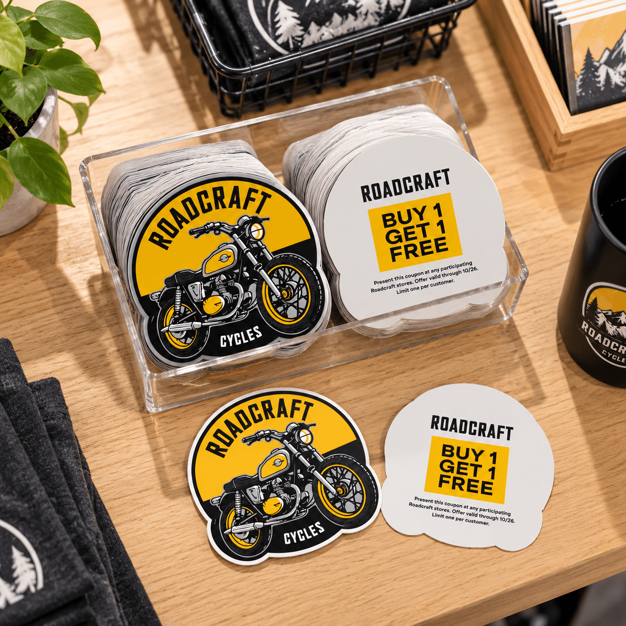 Backprinted motorcycle stickers displayed on a retail counter with promotional information printed on the back.