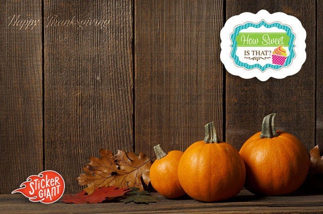 Three small pumpkins and autumn leaves arranged on a rustic wooden surface with a How Sweet Is That? custom-shaped logo sticker displayed above and a StickerGiant logo in the corner.