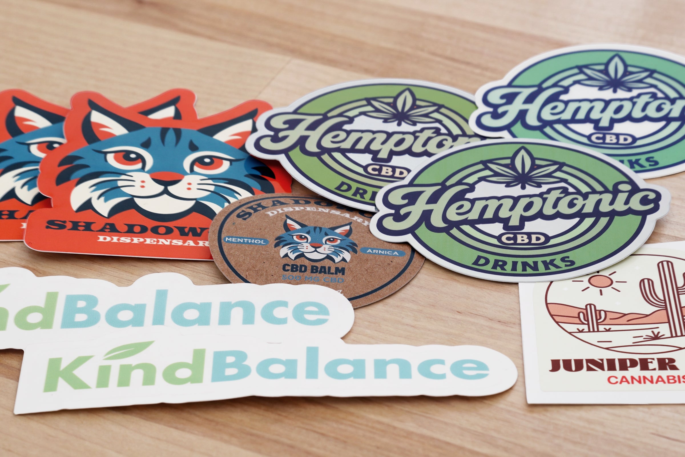 Custom cannabis brand stickers and product labels on display.