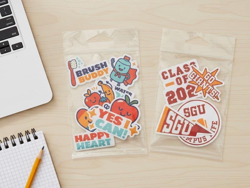 Colorful educational sticker packs featuring cartoon fruit characters and school-themed designs.