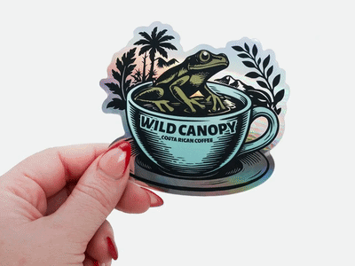 Holographic coffee brand sticker with frog illustration held in hand.