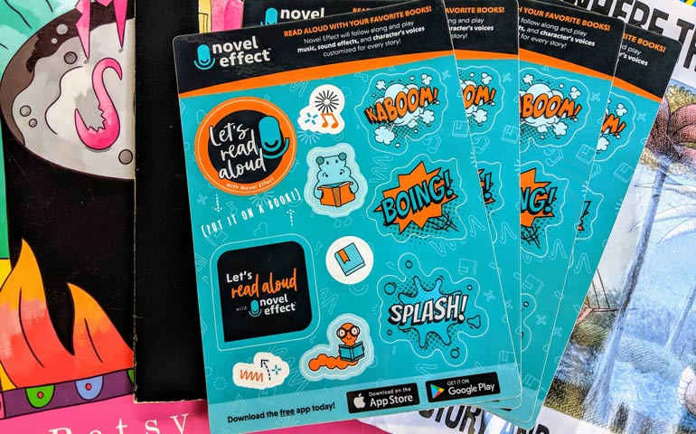 Custom Sticker Sheets printed for Novel Effect featuring colorful read-aloud themed stickers, including comic-style words like BOING, KABOOM, and SPLASH, displayed on top of children’s books.