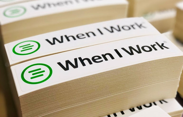 Stack of custom When I Work Kiss Cut Stickers featuring the brand’s green logo and black text.