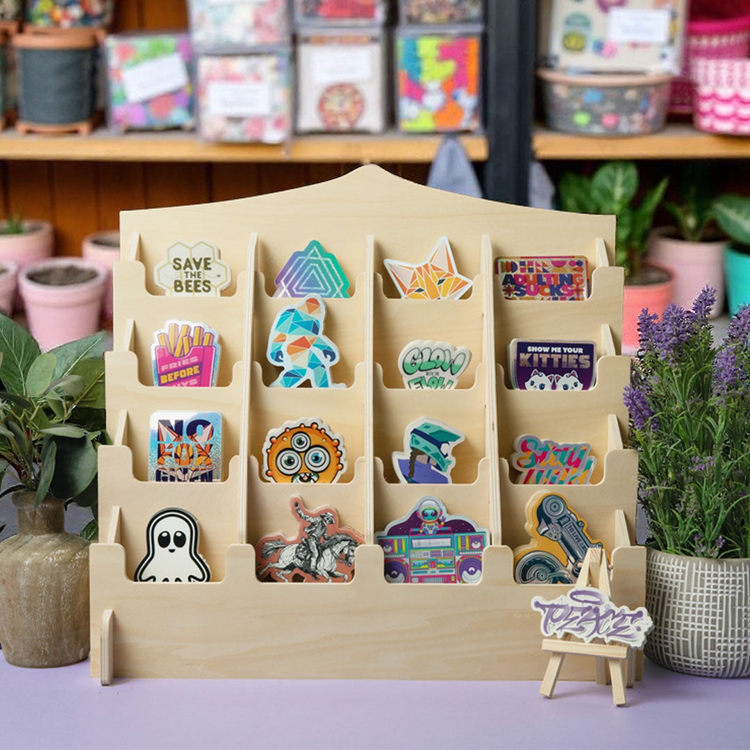 Custom stickers displayed on wooden stand with assorted designs