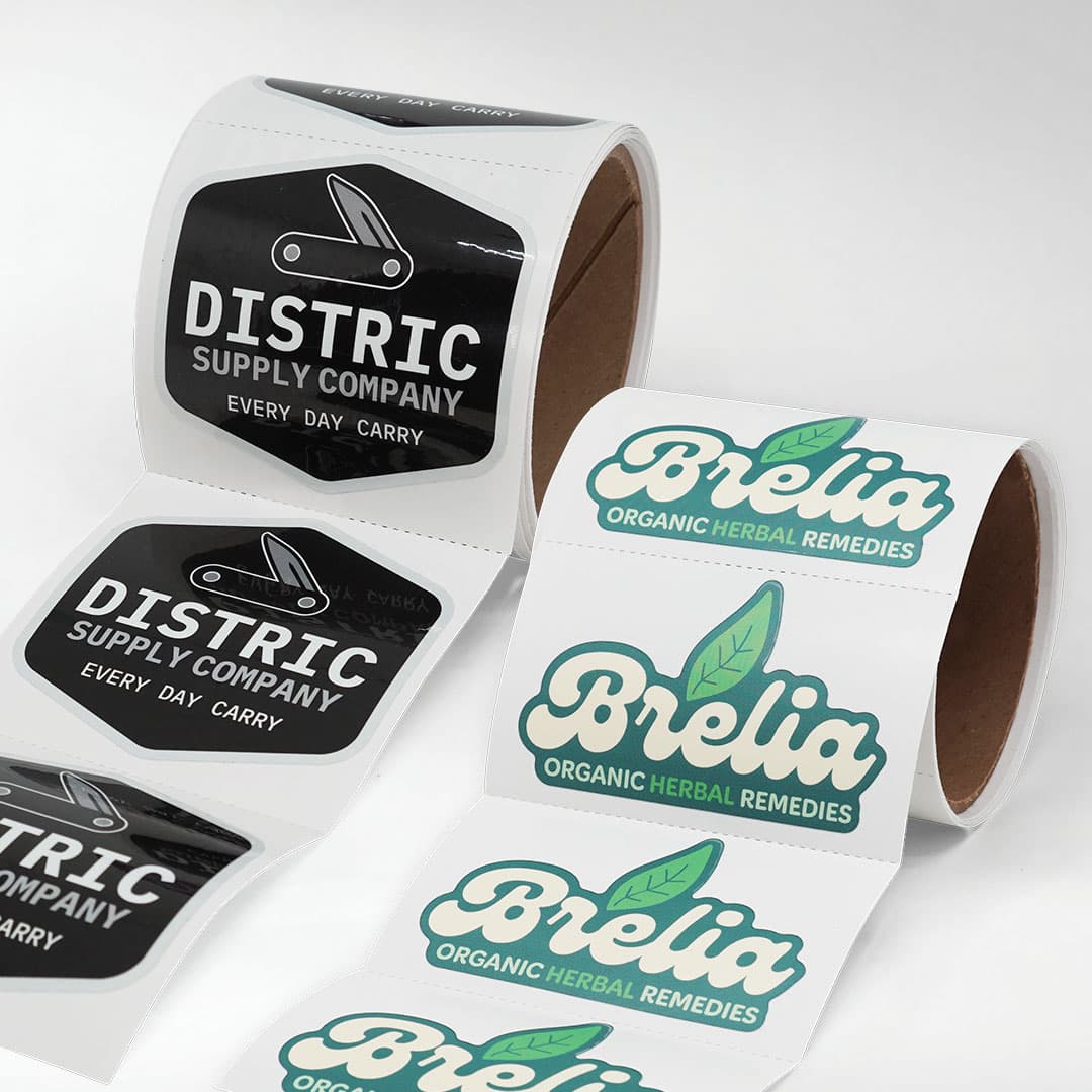 Custom kiss cut roll stickers featuring Brelia Organic Herbal Remedies and Distric Supply Company designs on rolls with easy peel kiss cut labels.