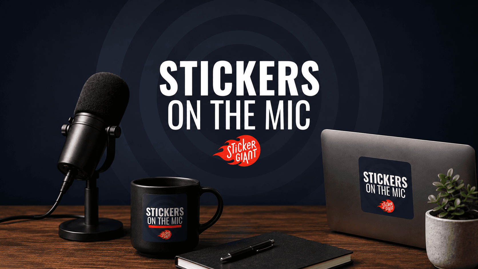 Stickers on the Mic podcast studio setup featuring a microphone, laptop, coffee mug, and notebook with StickerGiant branding.